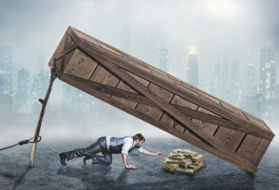36157077 - businessman trying to get money under big wooden box trap